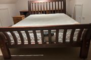 Wooden bed frame with slatted headboard and footboard