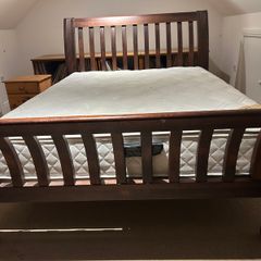 Wooden bed frame with slatted headboard and footboard