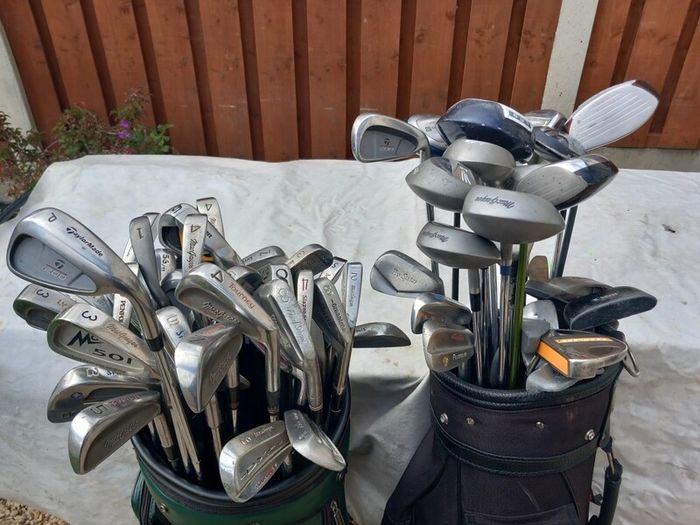 A selection of Golf clubs. Bags and golf balls.
