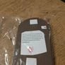 handcrafted wooden  Fairy door with red cardstock, brown flower cutouts, and decorative buttons.  various buttons acting as handles or embellishments. Image 4