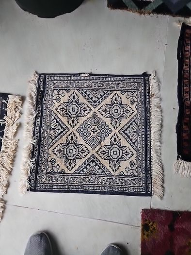 tiny wool rug...small mark on fringe.