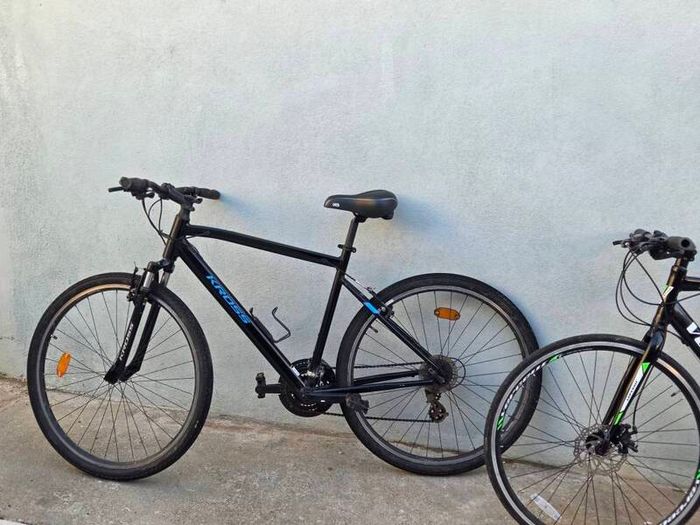 Two bikes one mountain one is a type of racing mountain bike