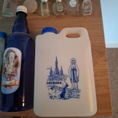 Empty holy water bottles and other religious items