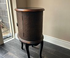 Oval side table with embossed doors