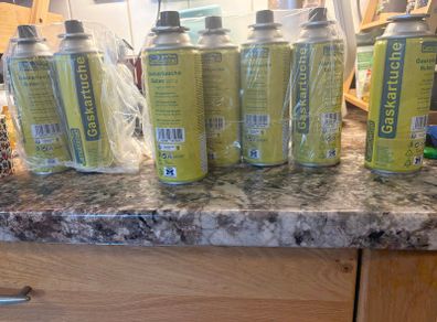 8 Camping gas canisters.