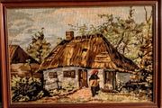 Framed tapestry with thatched cottage