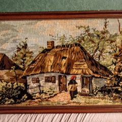 Framed tapestry with thatched cottage