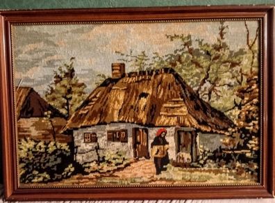 Framed tapestry with thatched cottage