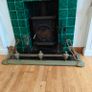 Art Nouveau orbed style cast brass hearth fender with a pair of companion orbed fire dogs Image 7