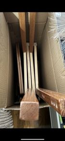 2 wooden chairs and a wall clock