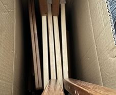2 wooden chairs and a wall clock