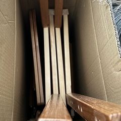 2 wooden chairs and a wall clock