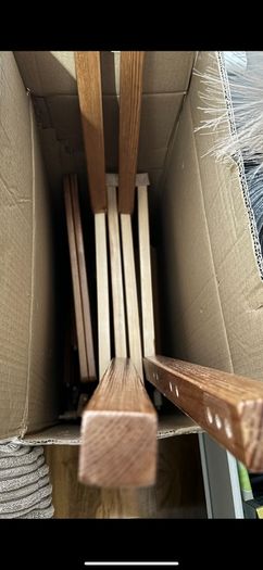2 wooden chairs and a wall clock