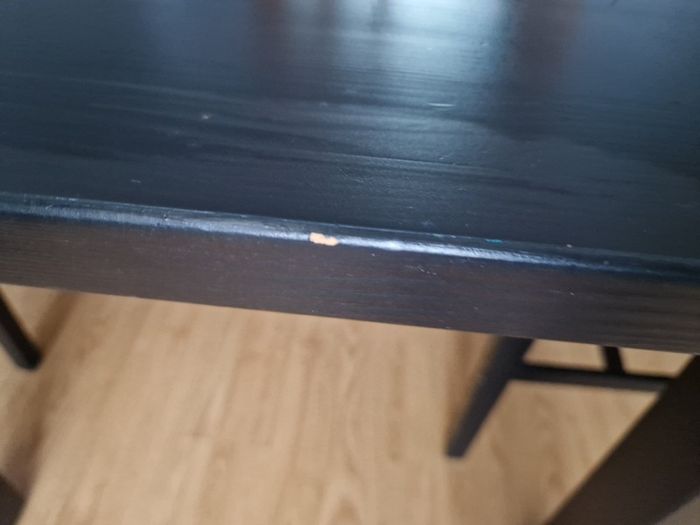 Black dining table with four chairs