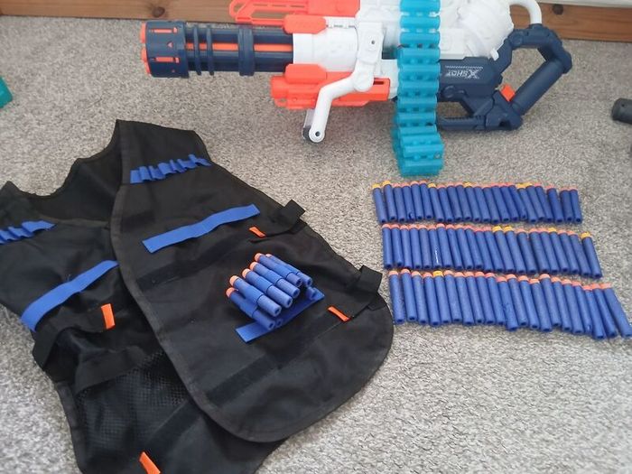 Nerf Gun extra large with bullets and gun vest to hold bullets.