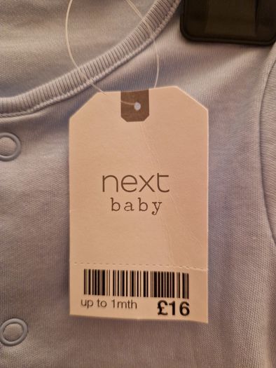 A selection of brand new baby clothes and items