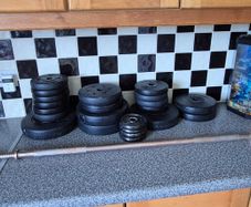 assortment of weights and barbell