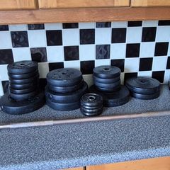 assortment of weights and barbell