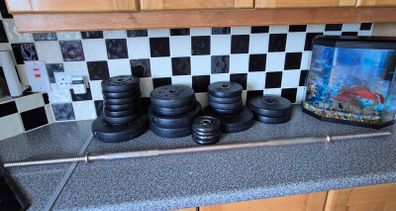 assortment of weights and barbell