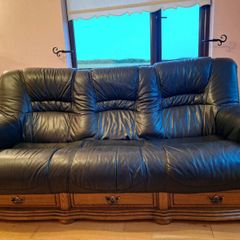 Black leather sofa with oak