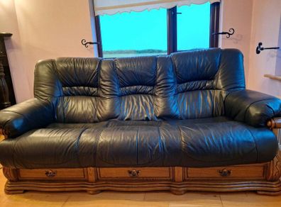 Black leather sofa with oak