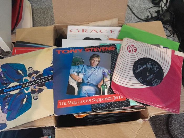 a box of 7" singles. 45 rpm vinyl records.