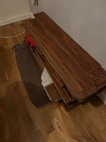 Beautiful Laminate Wood Flooring in dark wood taken up from a room measuring approximately 11 x 7 ft.