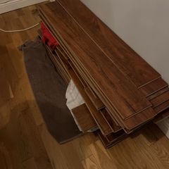 Beautiful Laminate Wood Flooring in dark wood taken up from a room measuring approximately 11 x 7 ft.