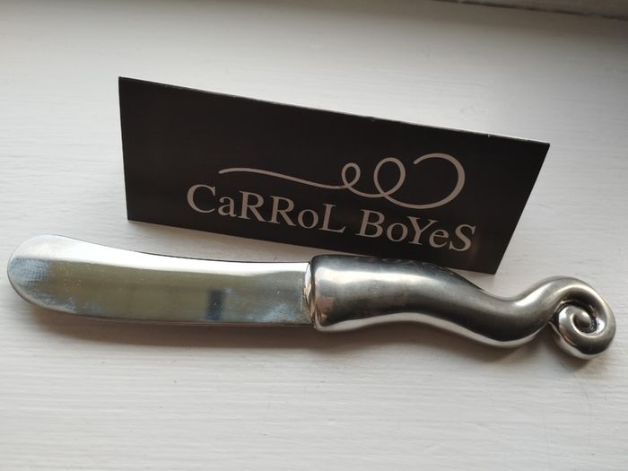 A collectible knife made of polished pewter with a stainless steel blade from Carrol Boyes.
