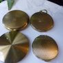 A Collection of Mid-Century Compacts. Tallent Enamel, Kigu, a Courting Couple Novelty Piece and a Henriette Pocket-Watch Compact Image 2