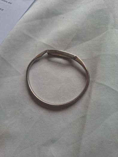 Sculptural sterling silver bangle with three tiny diamond accents.