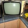 Ideal Prop, Vintage Working Boots Audio TV12 Portable Black and White CRT Television, featuring a cream plastic casing with side control dials and a 12 inch screen. Designed with dual power capabilities supporting standard mains voltage (240V) as well as  Image 2