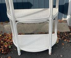 White wicker shelving unit
