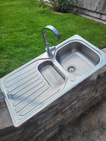 A double kitchen sink with tap