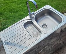 A double kitchen sink with tap