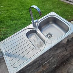 A double kitchen sink with tap