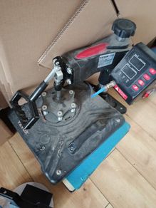 heat press with unused attachment for caps and mugs