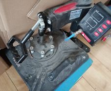 heat press with unused attachment for caps and mugs