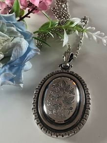 Victorian Sterling Silver Locket with beautiful engraved Ivy Leaves on both sides and & raised detailing around the edge. The locket is late 1800s It hold a bouquet of dried flowers inside. Choice of 18" or 30" Chain. Please PM for details. Katie P.