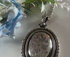 Victorian Sterling Silver Locket with beautiful engraved Ivy Leaves on both sides and & raised detailing around the edge. The locket is late 1800s It hold a bouquet of dried flowers inside. Choice of 18" or 30" Chain. Please PM for details. Katie P.