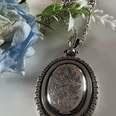 Victorian Sterling Silver Locket with beautiful engraved Ivy Leaves on both sides and & raised detailing around the edge. The locket is late 1800s It hold a bouquet of dried flowers inside. Choice of 18" or 30" Chain. Please PM for details. Katie P.