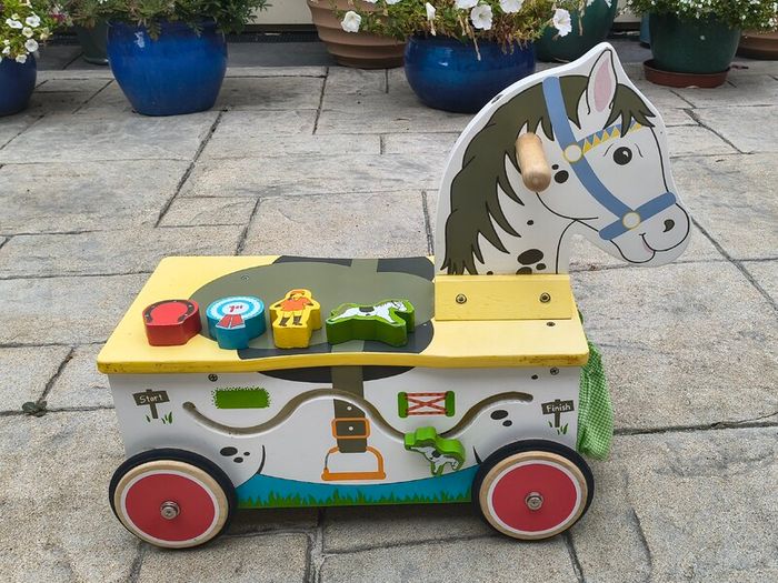 Wooden horse-themed ride-on toy in good used condition