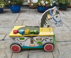 Wooden horse-themed ride-on toy in good used condition