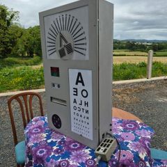 vintage optician's illuminated eye test chart, commonly used in the mid-20th century.