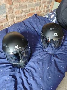 pair of helmets, one full face one open face