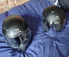 pair of helmets, one full face one open face