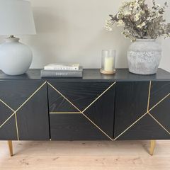 Black sideboard with gold accents