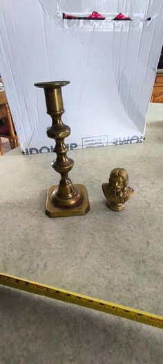 2 BRASS ITMEES-1- Primitive Antique Early Country Brass Push Up 9.5 INCHES Candlestick55.00 euro. 2- Brass Oliver Plunkett Tapper or papper wighte 60.00 euro.