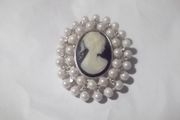 a costome jewelley brooch with cameo and pearls