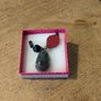 necklace featuring a striped black agate gemstone pendant and a distinct red geometric bead. Image 2